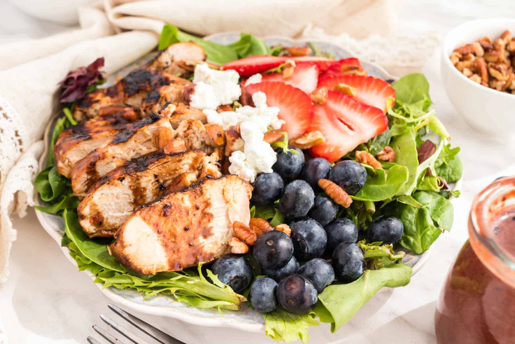 Mixed greens topped with grilled chicken, blueberries, strawberries, goat cheese, pecans, and blueberry balsamic vinaigrette