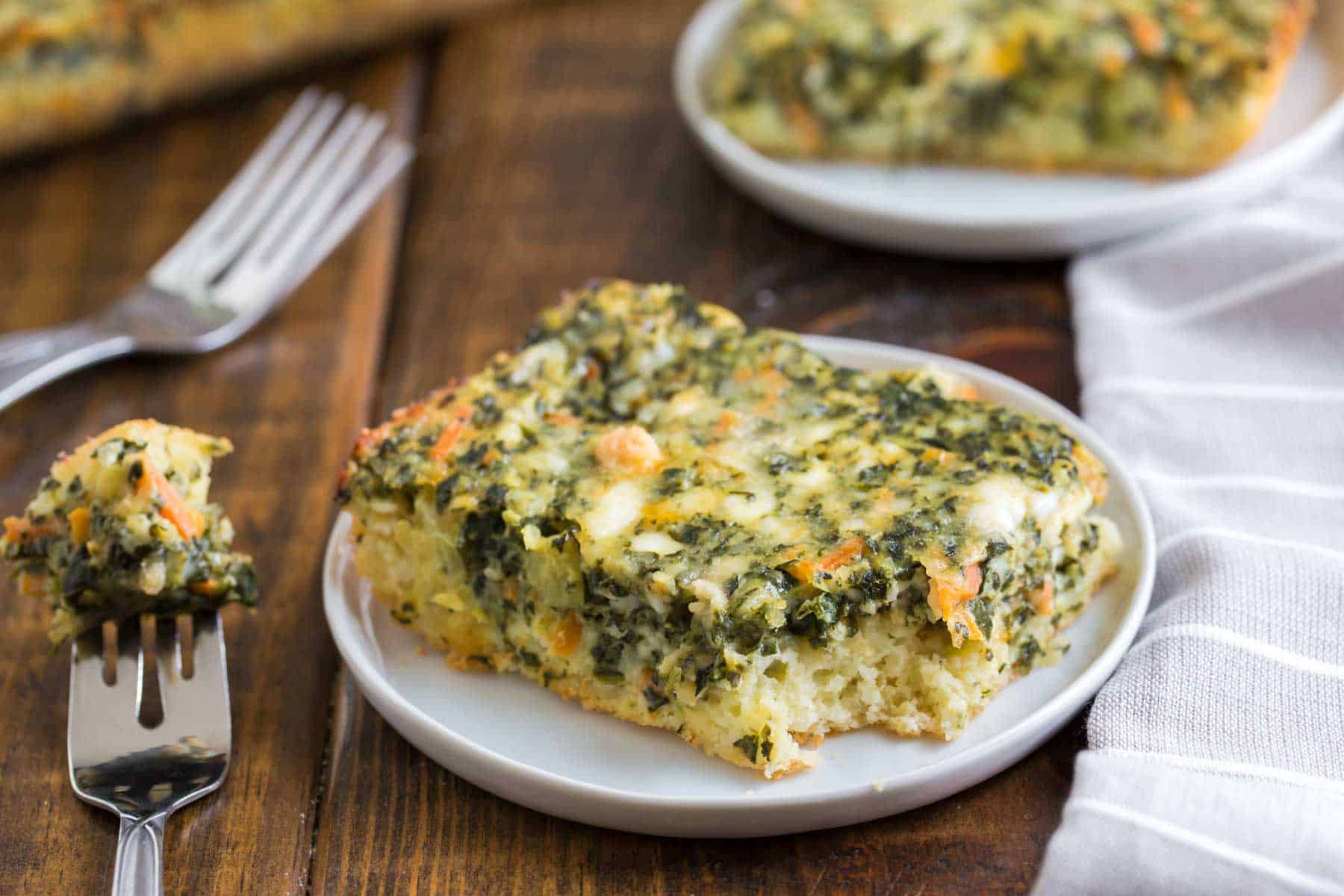 Squares of Vegetarian Breakfast Casserole on white plates