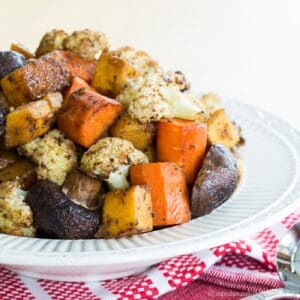 A bowl of Balsamic Roasted Vegetables on red and white cloth napkins.