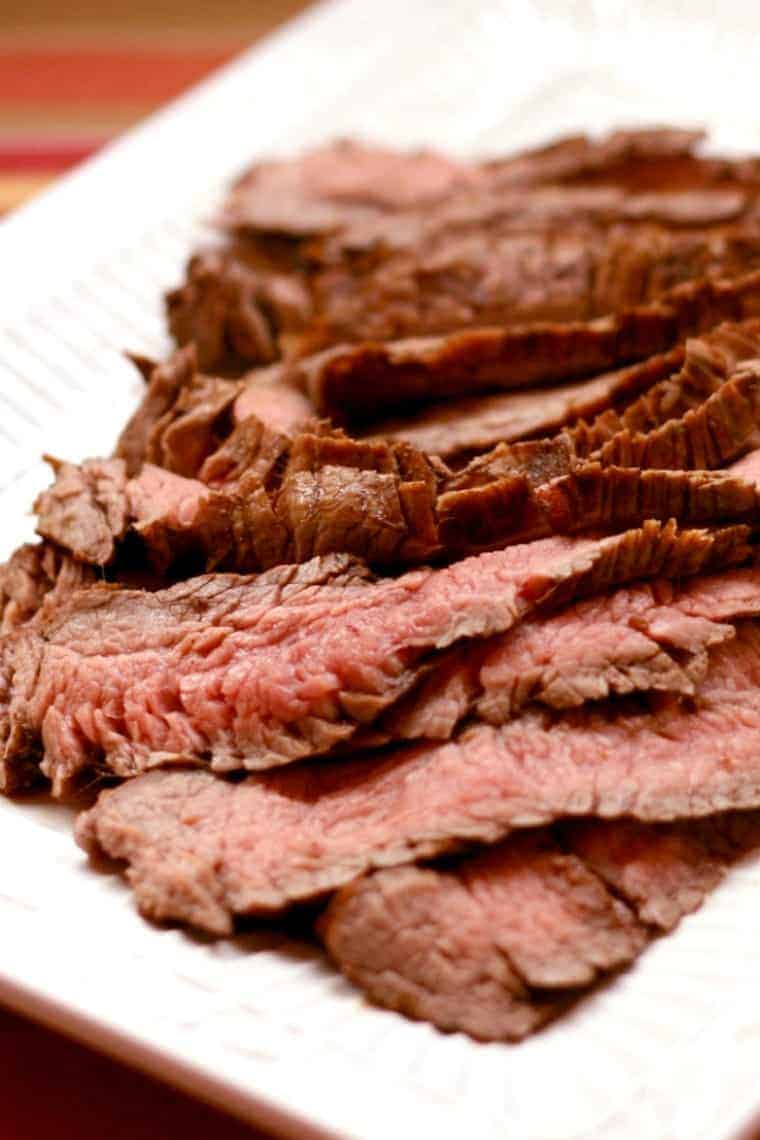 Grilled Flank Steak on a white rectangular plate