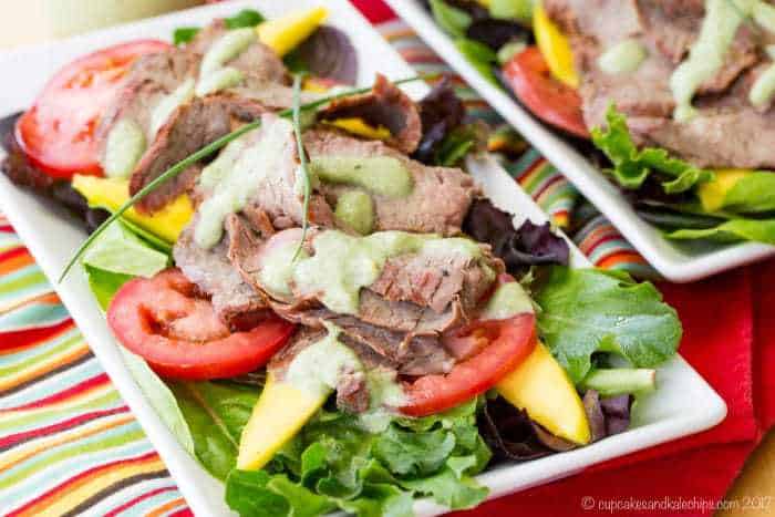 Avocado Ranch Steak Salad with Mango on white rectangular plates