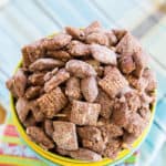 Looking down at Almond Joy Puppy Chow overfilling three stacked bowls.