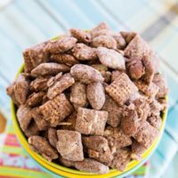 Looking down at Almond Joy Puppy Chow overfilling three stacked bowls.