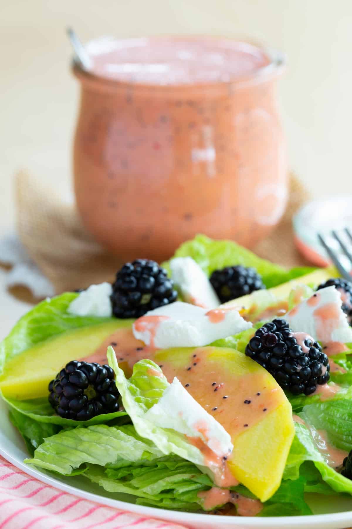 Salad with blackberries, mango sliced, goat cheese, and poppyseed dressing.
