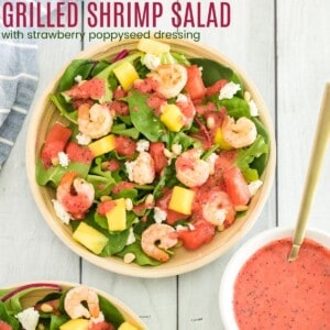 Fruity Grilled Shrimp Salad in a bowl next to a small bowl of strawberry poppyseed vinaigrette