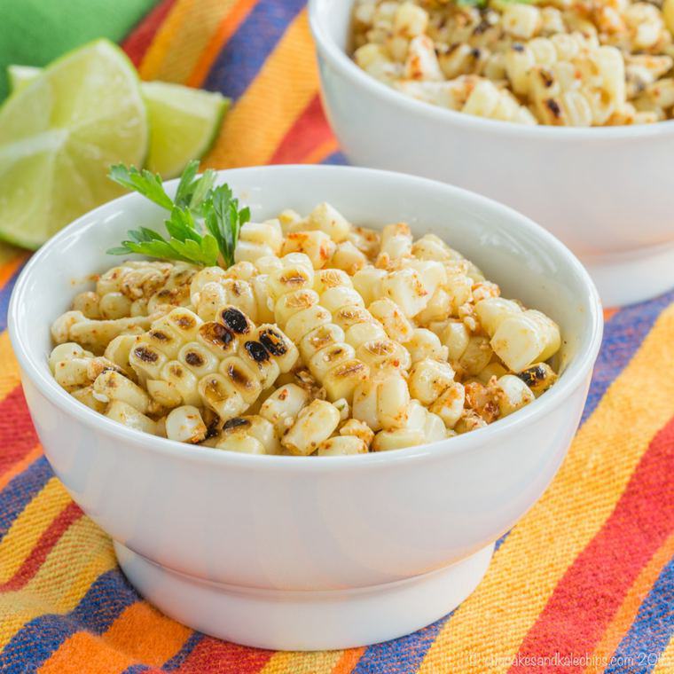 Two bowls of charred chili lime corn kernels garnished with cilantro.