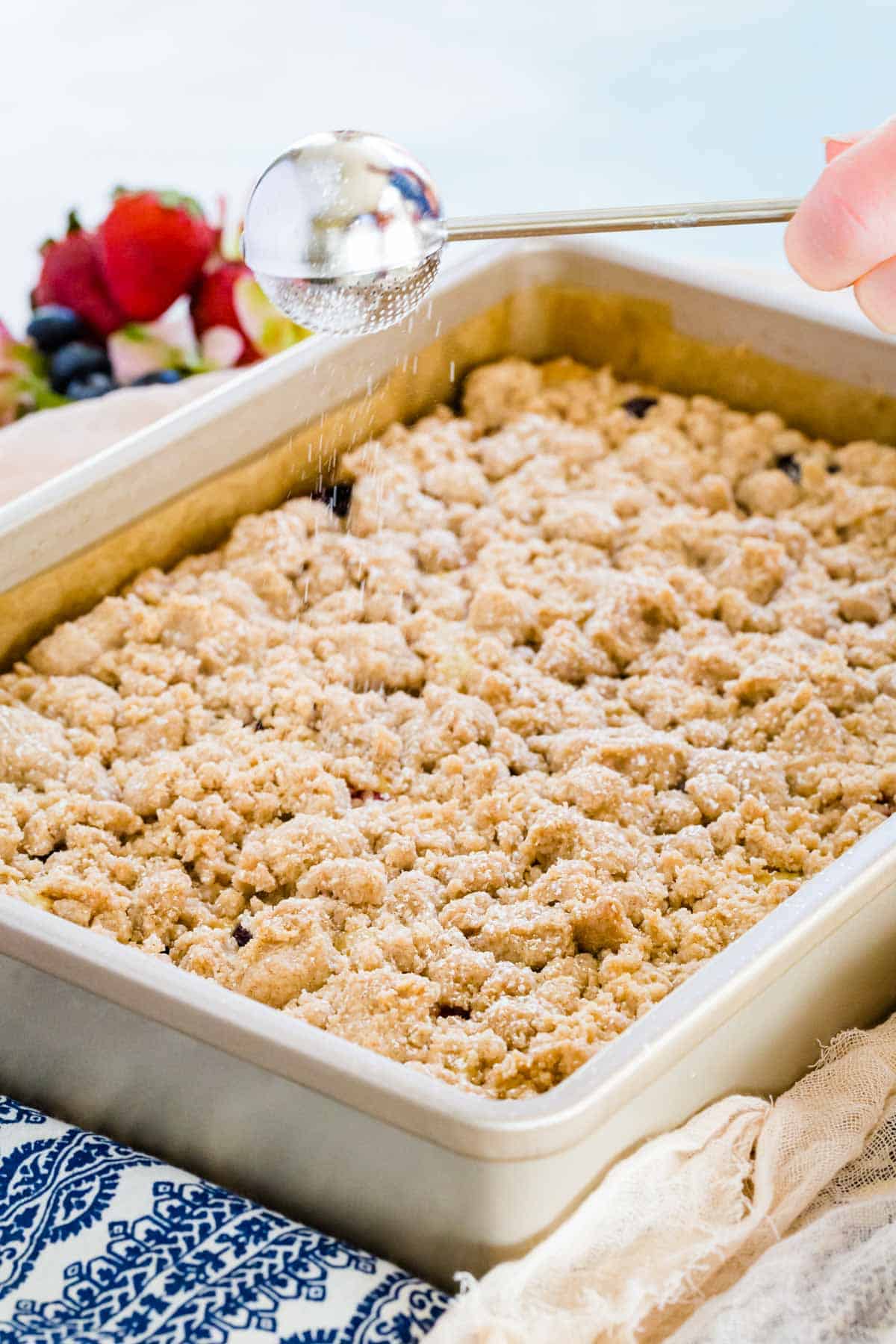 A whole baked crumb cake in a baking pan.