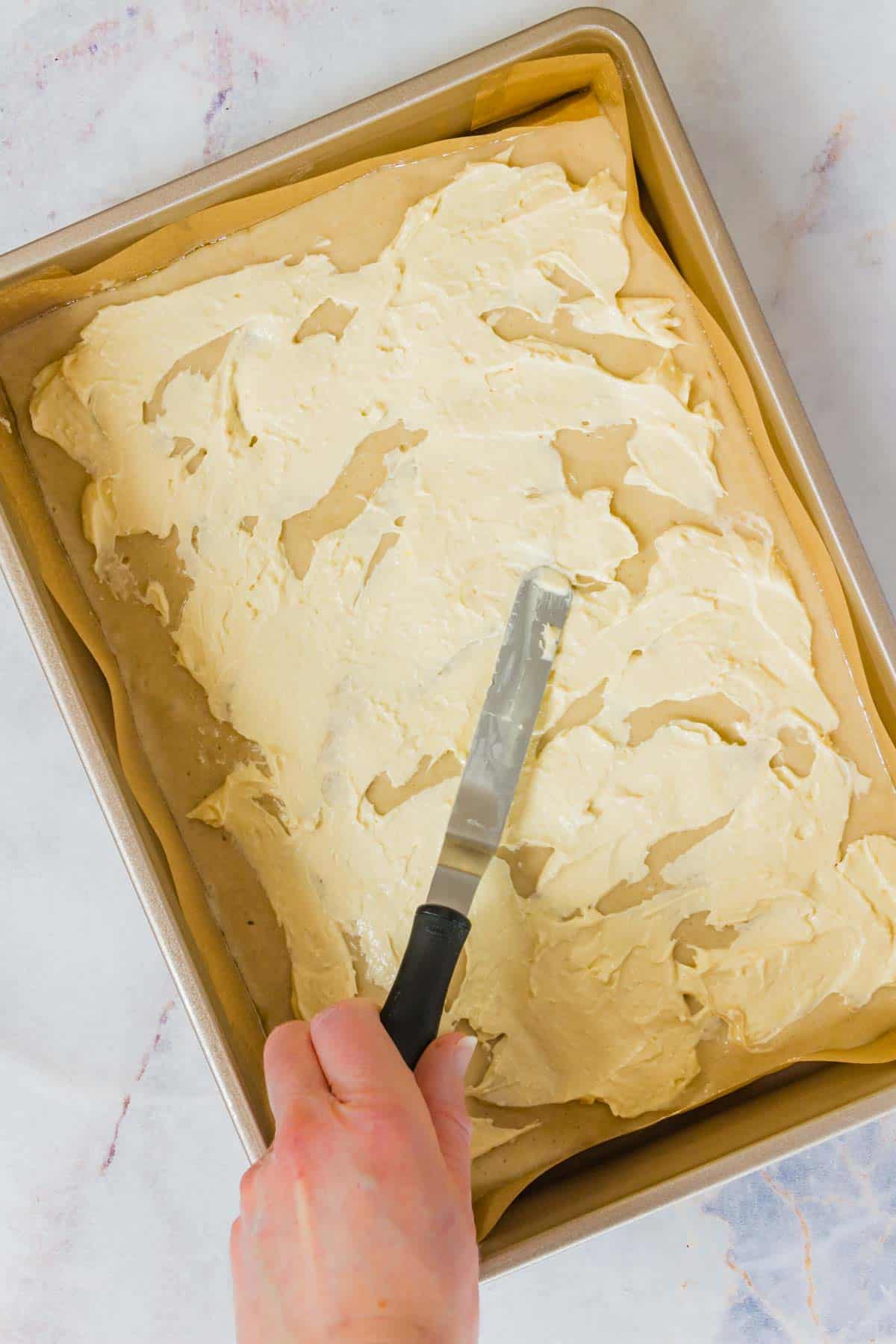 Cream cheese mixture is spread overtop the cake layer.