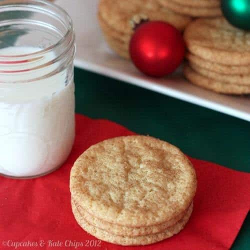 Three Snickerdoodle cookies on a red napkin with milk