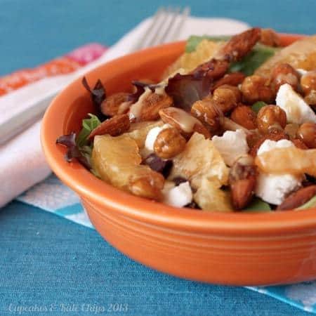 Orange roasted chickpeas, creamy goat cheese, and spiced almonds are a delicious combination in this quick and easy-to-make dinner salad. Topped with sherry citrus vinaigrette | @cupcakekalechips