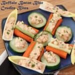 Crudites topped with bacon blue cheese buffalo dip arranged on a plate.