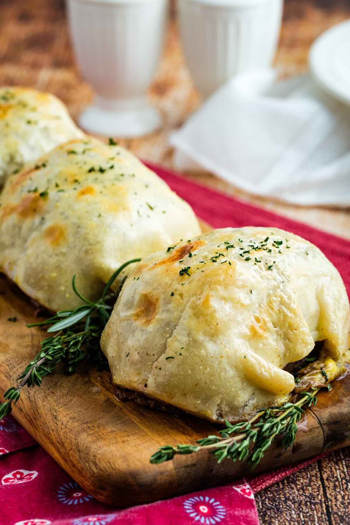 Individual Beef Wellingtons on a cutting board