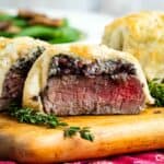 Individual Beef Wellingtons on a cutting board showing the inside