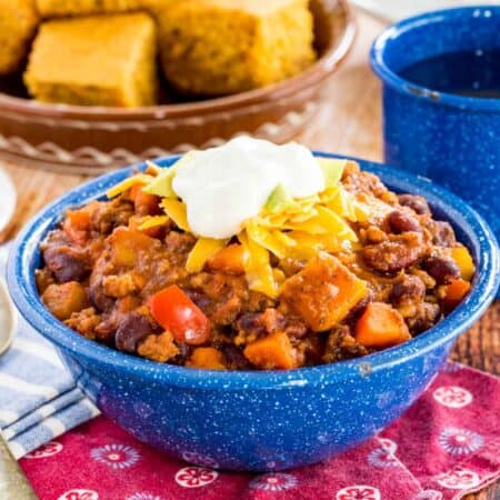 Slow cooker Aloha chili in a bowl topped with sour cream.