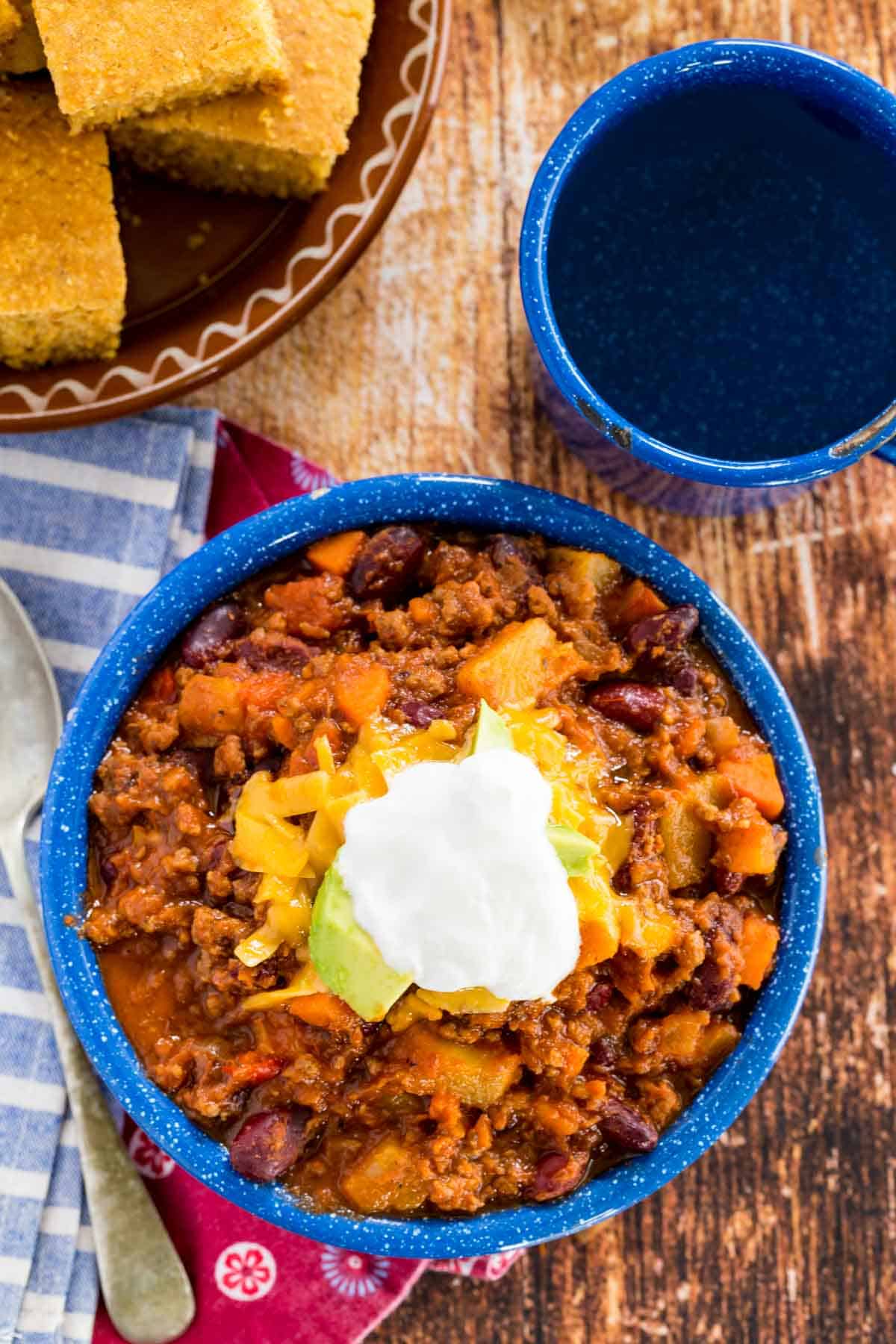 Top view of slow cooker chili topped with sour cream.