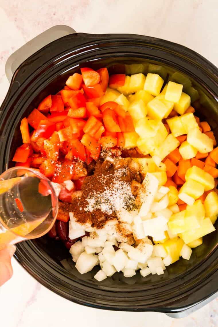 The other chili ingredients are added into the slow cooker.