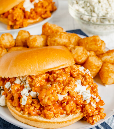 Buffalo chicken sloppy joes on a plate with tater tots