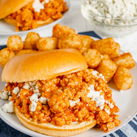 Buffalo chicken sloppy joes on a plate with tater tots