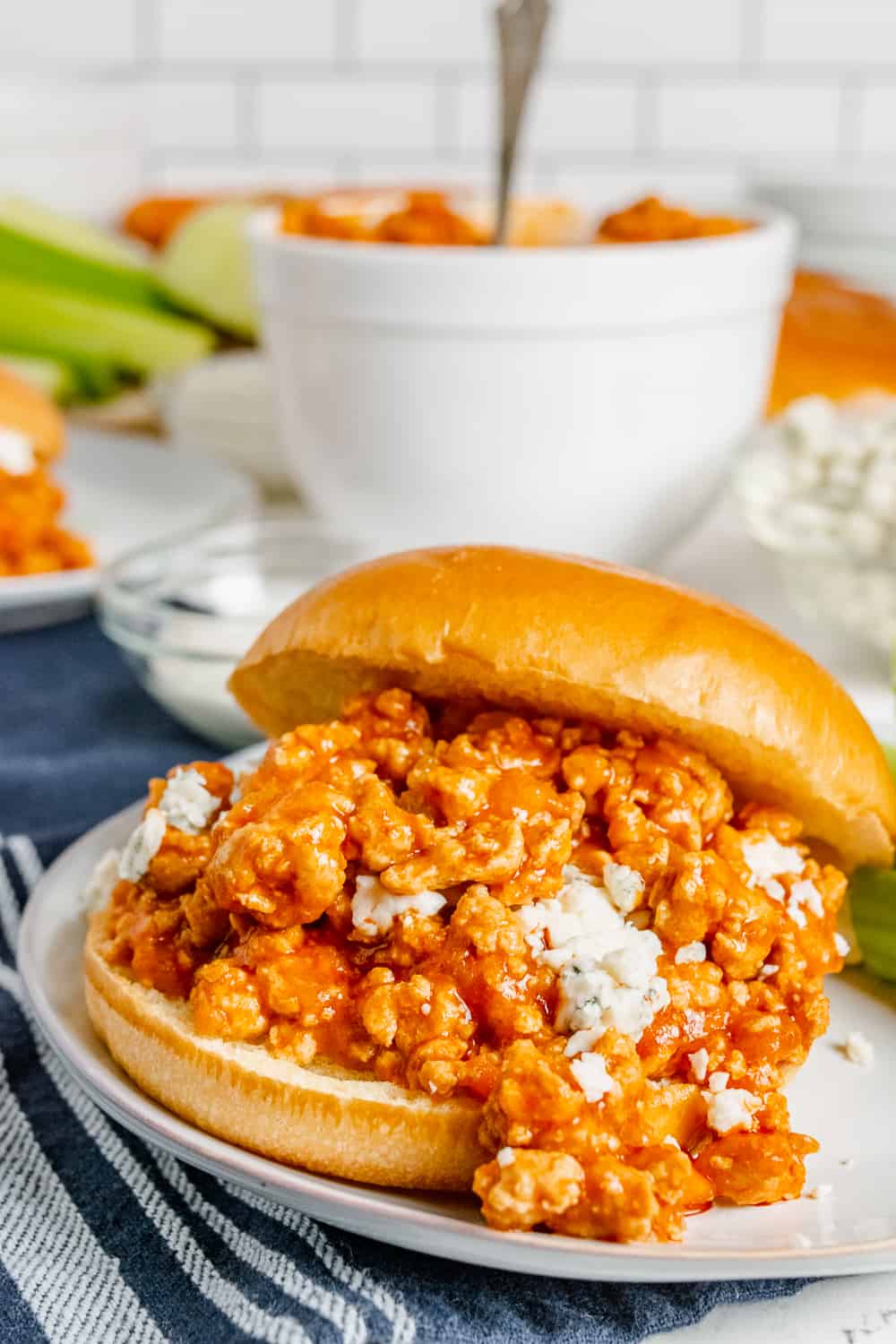 Buffalo chicken sloppy joes sandwich on a bun with crumbled blue cheese