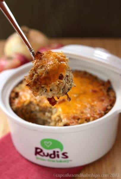 A bowl full of gluten-free apple, bacon and cheese stuffing.