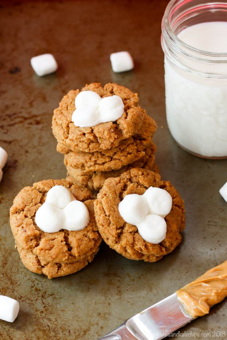 stacked up fluffernutter cookies and a glass of milk