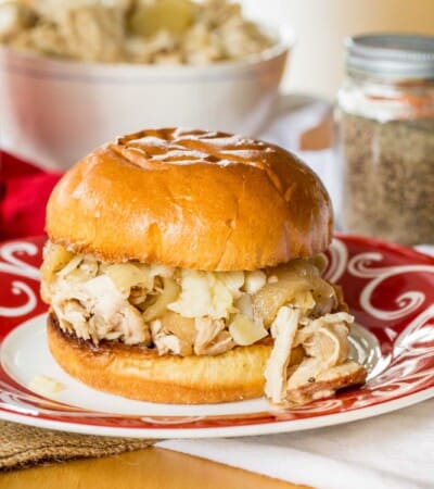 crockpot pulled chicken with apples on a roll with cheddar cheese