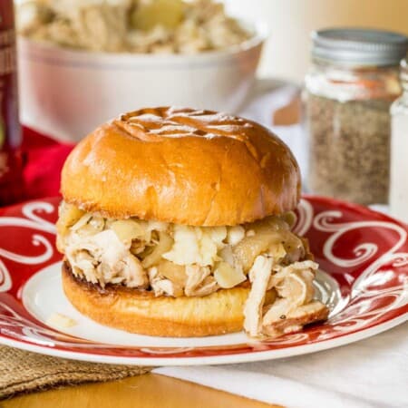 crockpot pulled chicken with apples on a roll with cheddar cheese