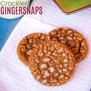 Three gingersnap cookies with a crackled sugar topping