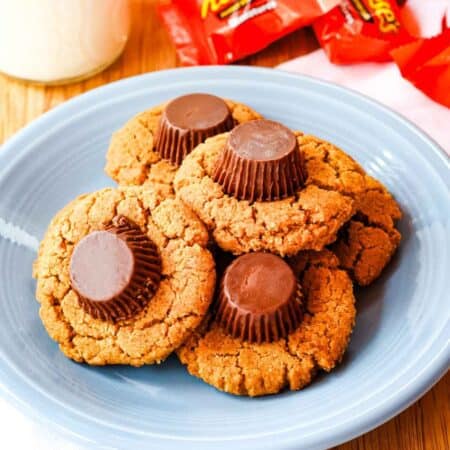 Five Flourless Reese's Peanut Butter Cookies on a blue plate.