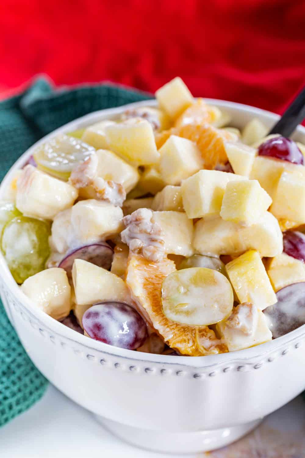 A closeup of a bowl of creamy fruit salad.