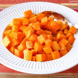 Diced roasted butternut squash in a white serving dish.