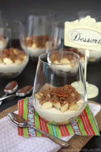 A bananas foster cheesecake parfait in a glass.