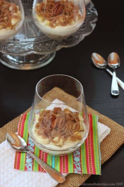 A bananas foster cheesecake parfait in a glass.