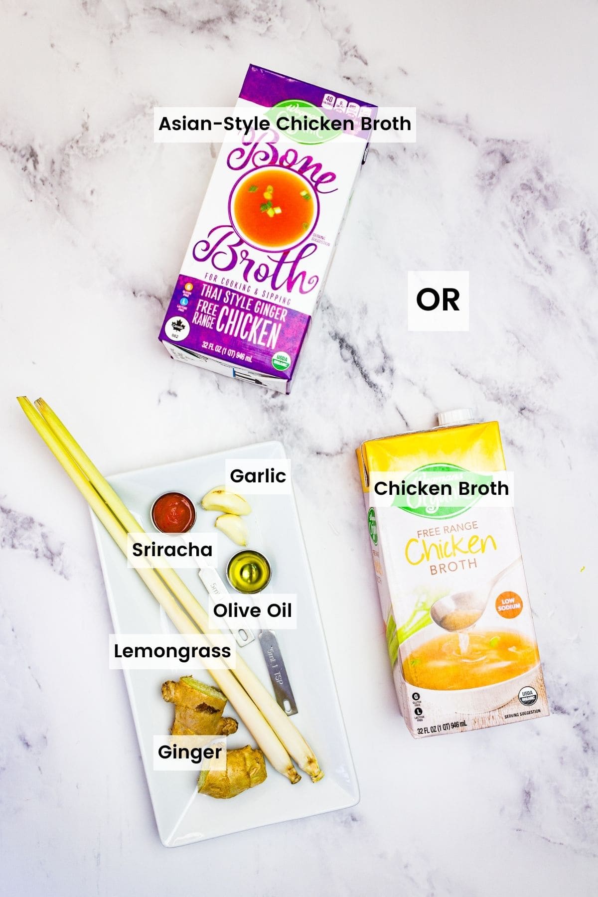 A carton of Asian-style chicken broth, a carton of regular broth and the ingredients to make Asian broth