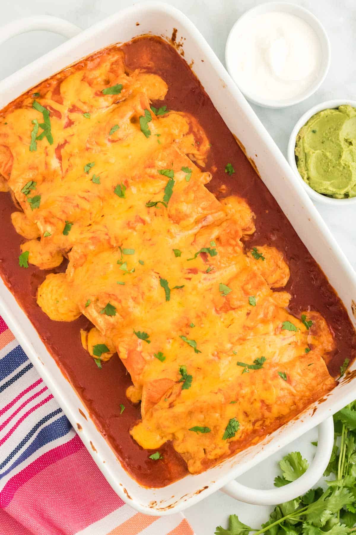 Baked chicken enchiladas in a rectangular baking dish.