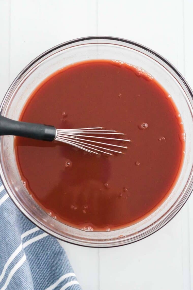 The red wine gravy is whisked together in a mixing bowl.