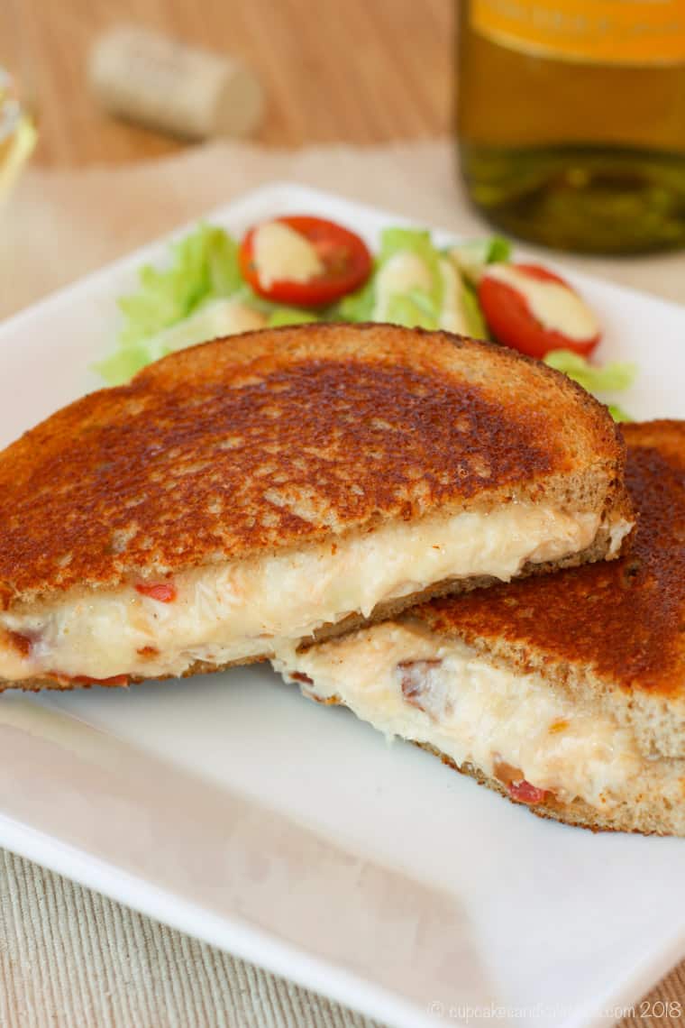 Grilled cheese served on a plate with a salad