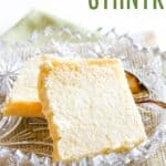 Two square pieces of the sweet cheese in a crystal dish with text overlay that says "Ukrainian Easter Cheese - Syrnyk".