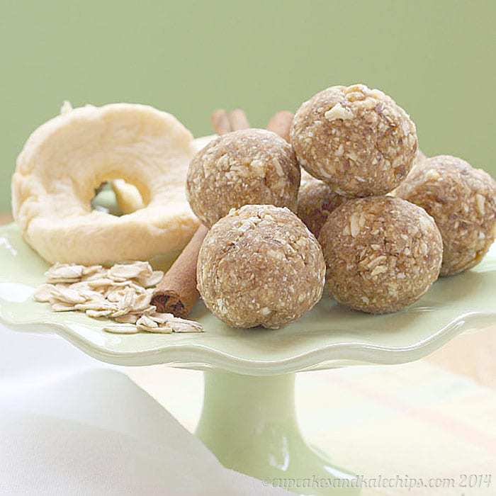 Easy Nut-Free Apple Energy Balls Recipe on a green pedestal with the four ingredients to make them