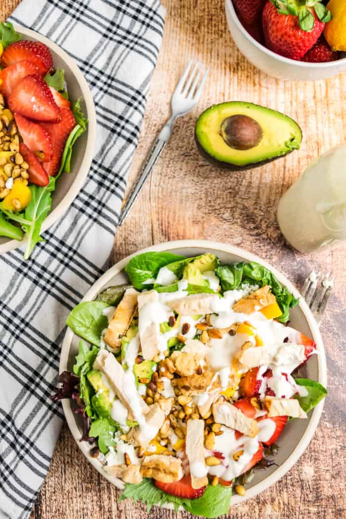 Overhead of a boal of Strawberry Mango Avocado Salad with Grilled Chicken and Honey Lemon Lime Dressing