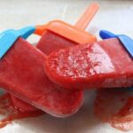 Three slightly melted Strawberry Mango Lime Popsicles