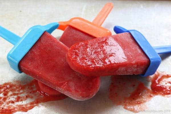 Three slightly melted Strawberry Mango Lime Popsicles