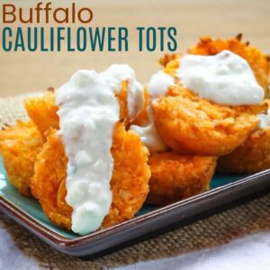 Buffalo cauliflower tots on a turquoise plate with blue cheese dressing on top