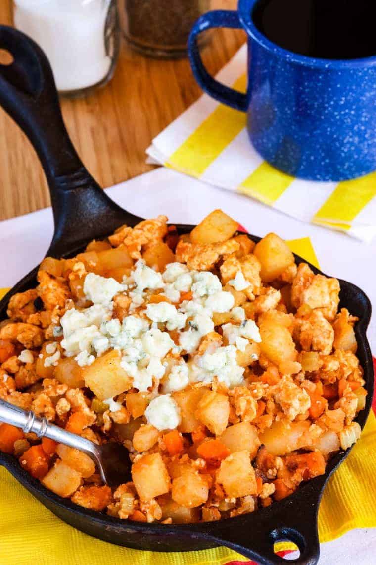 Fork in a pan of Buffalo Chicken Hash with potatoes