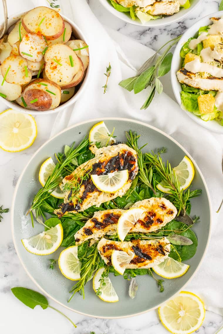 Overhead of Lemon Herb chicken on a pile of greens on a plate