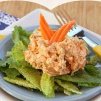 Buffalo Chicken Salad with blue cheese on top of fresh greens.