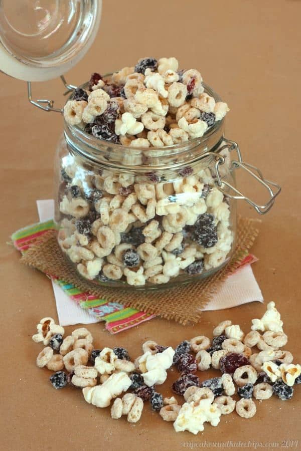 Very Berry Cheerios Popcorn Snack Mix in a glass mason jar.