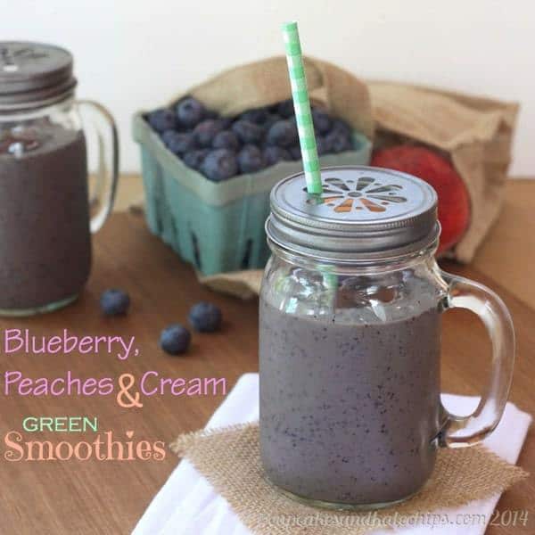 A Blueberry and Peach Green Smoothie in a sipping cup with a straw.