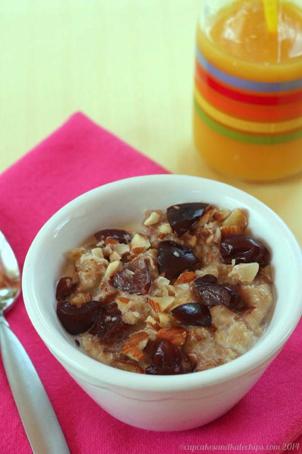 Freezer Oatmeal Cups with cherries and almonds reheated in a bowl