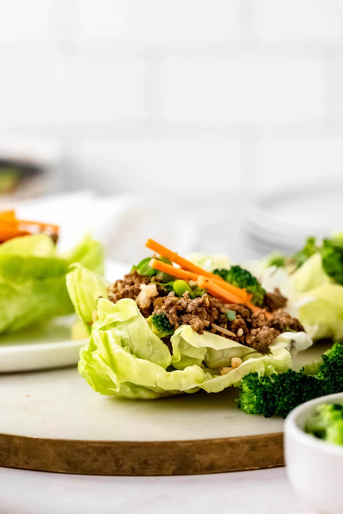 An Asian beef and broccoli lettuce wrap on a countertop.
